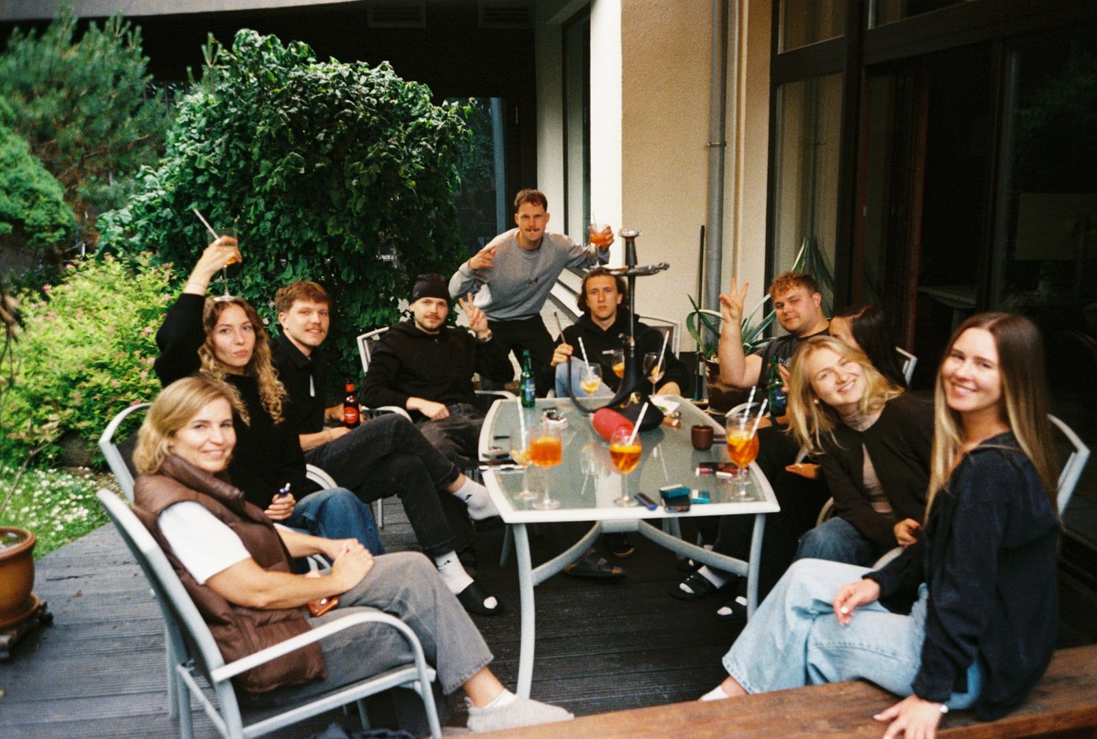 The team gathered around a table in a garden
