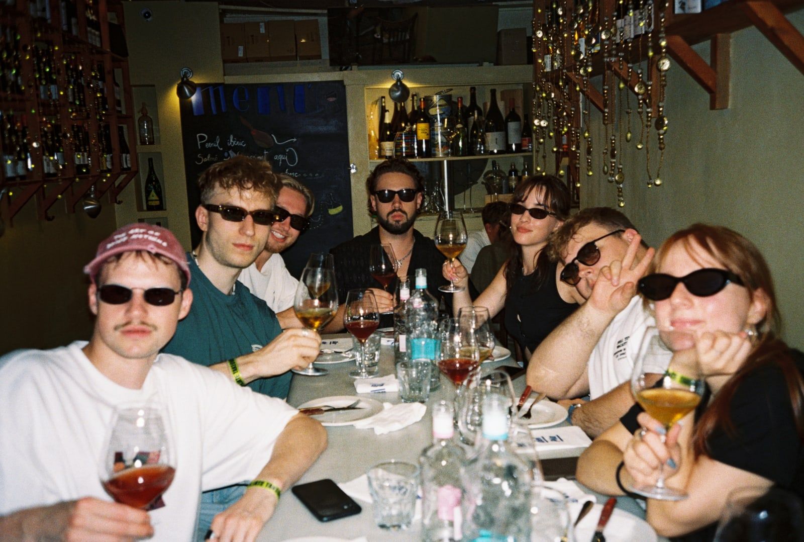 Colleagues in sunglasses around a dinner table